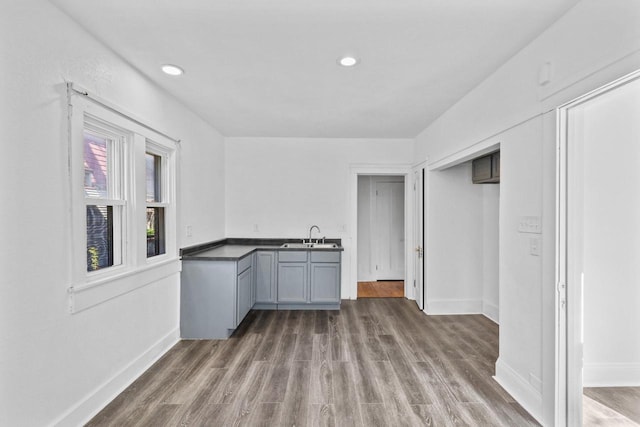2535 N 48th St, Milwaukee, WI 53210 - interior space featuring a sink, baseboards, wood finished floors, and recessed lighting