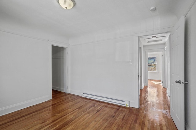 2535 N 48th St, Milwaukee, WI 53210 - unfurnished room with baseboard heating, wood-type flooring, and baseboards