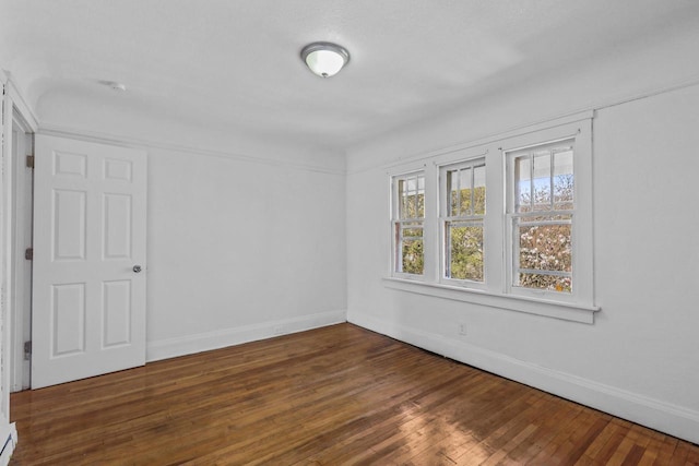 2535 N 48th St, Milwaukee, WI 53210 - unfurnished room with baseboards and hardwood / wood-style floors