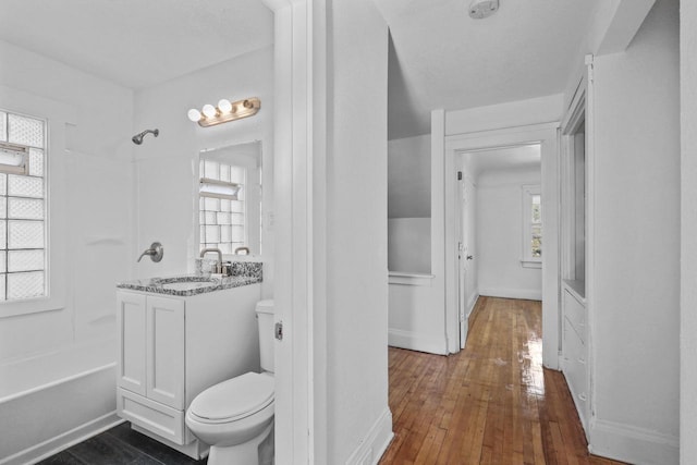 2535 N 48th St, Milwaukee, WI 53210 - full bathroom with toilet, hardwood / wood-style floors, vanity, baseboards, and washtub / shower combination