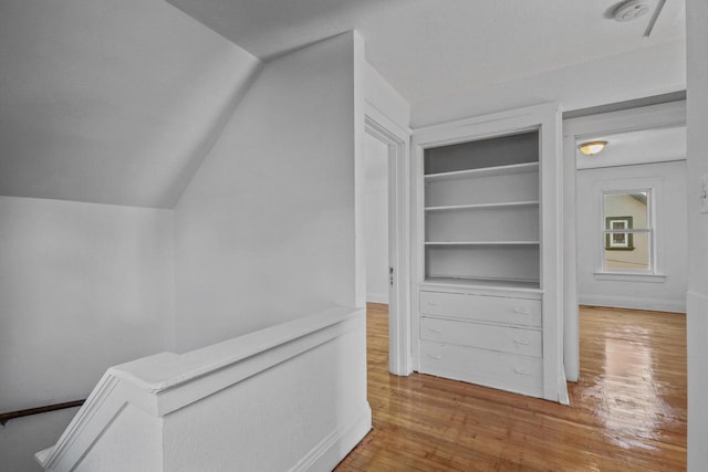 2535 N 48th St, Milwaukee, WI 53210 - corridor with wood finished floors, baseboards, lofted ceiling, and built in shelves