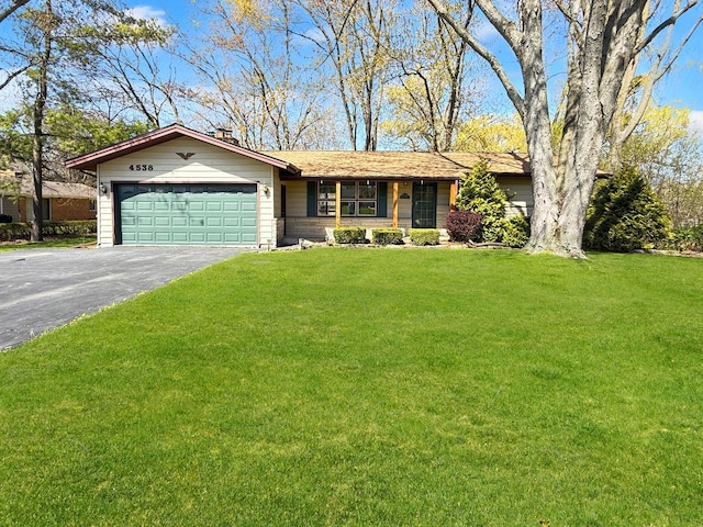 4538 Oakdale Dr, Racine, WI 53405 - ranch-style house featuring driveway, a garage, and a front lawn