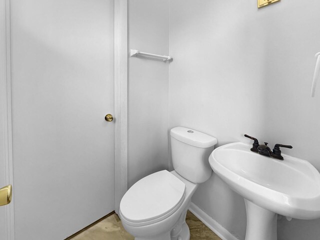 4538 Oakdale Dr, Racine, WI 53405 - bathroom featuring a sink, toilet, and baseboards