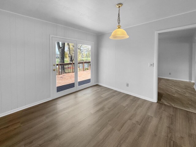4538 Oakdale Dr, Racine, WI 53405 - unfurnished dining area with wood finished floors and baseboards