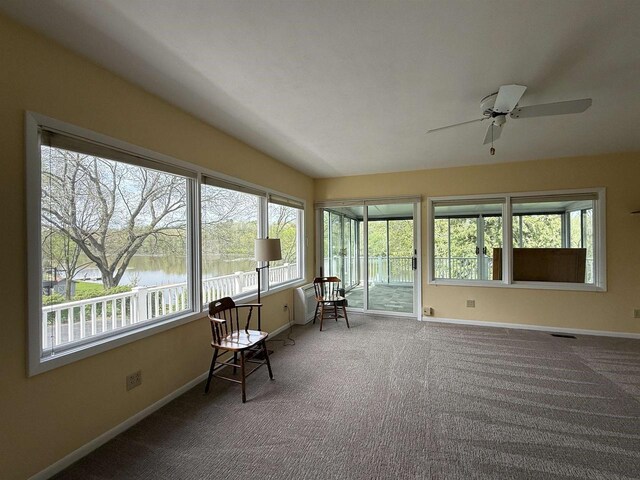1263 N Parker Dr, Janesville, WI 53545 - sunroom / solarium with healthy amount of natural light, baseboards, a water view, and carpet floors