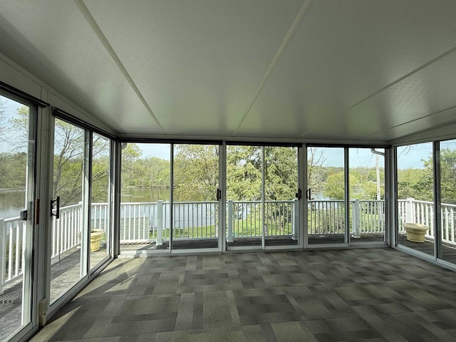 1263 N Parker Dr, Janesville, WI 53545 - unfurnished sunroom featuring a water view and view of wooded area