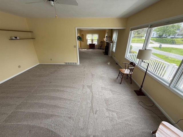1263 N Parker Dr, Janesville, WI 53545 - carpeted spare room featuring ceiling fan, baseboards, and a fireplace