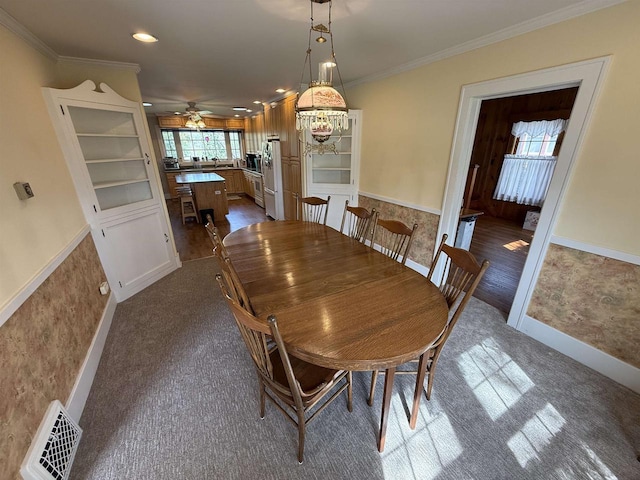 1263 N Parker Dr, Janesville, WI 53545 - dining room featuring crown molding, ceiling fan, dark carpet, recessed lighting, and baseboards