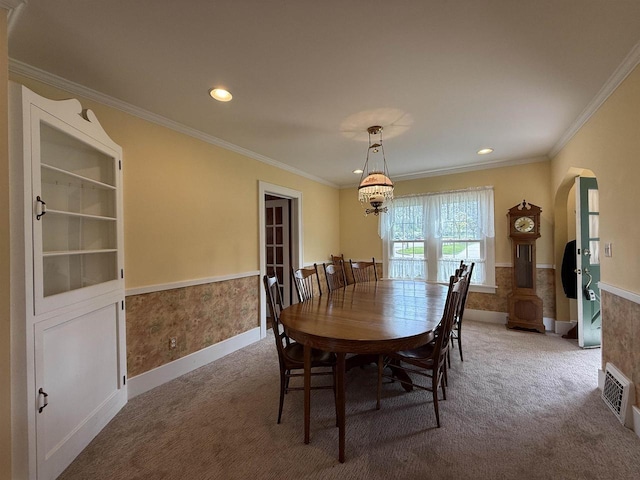 1263 N Parker Dr, Janesville, WI 53545 - dining space featuring arched walkways, carpet, a wainscoted wall, crown molding, and recessed lighting