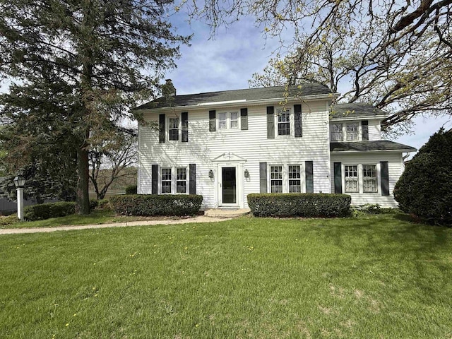 1263 N Parker Dr, Janesville, WI 53545 - colonial-style house featuring a front lawn and a chimney
