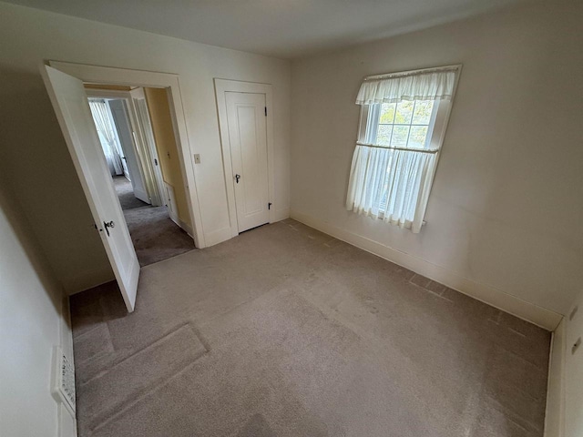 1263 N Parker Dr, Janesville, WI 53545 - unfurnished bedroom featuring carpet, baseboards, and a closet
