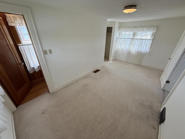 1263 N Parker Dr, Janesville, WI 53545 - unfurnished bedroom with light carpet, a closet, and baseboards