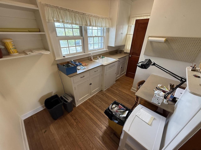 1263 N Parker Dr, Janesville, WI 53545 - kitchen with dark wood-style floors, white cabinetry, a sink, and light countertops