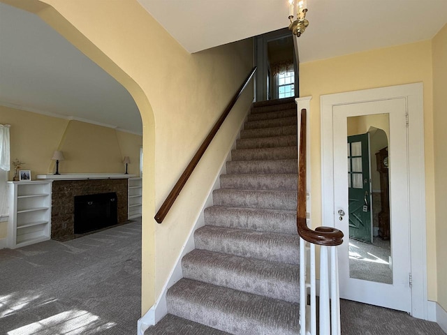 1263 N Parker Dr, Janesville, WI 53545 - staircase with carpet, a fireplace with flush hearth, and arched walkways