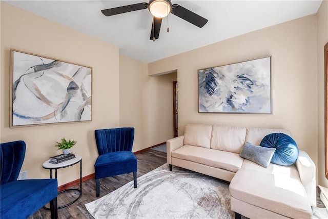 living area with wood finished floors, ceiling fan, and baseboards