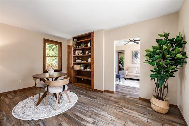 sitting room with baseboards and wood finished floors