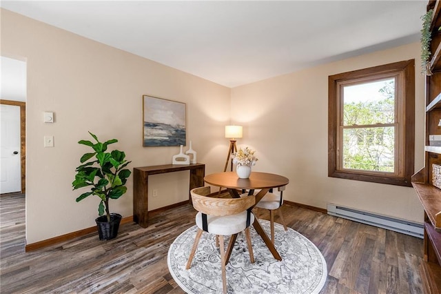 dining area featuring baseboard heating, wood finished floors, and baseboards