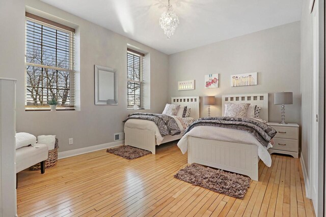 9302 39th Ave, Pleasant Prairie, WI 53158 - bedroom with hardwood / wood-style flooring, a chandelier, and baseboards