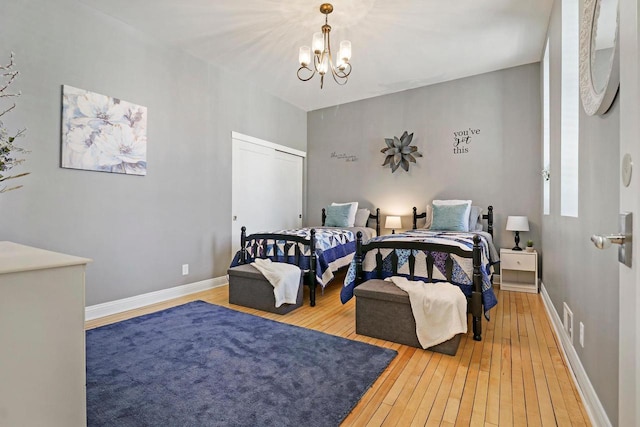 9302 39th Ave, Pleasant Prairie, WI 53158 - bedroom with wood-type flooring, a chandelier, baseboards, and a closet