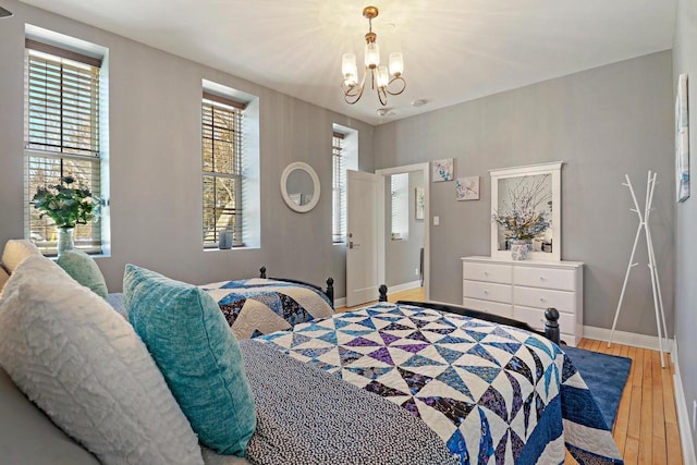 9302 39th Ave, Pleasant Prairie, WI 53158 - bedroom with hardwood / wood-style floors, baseboards, and a chandelier