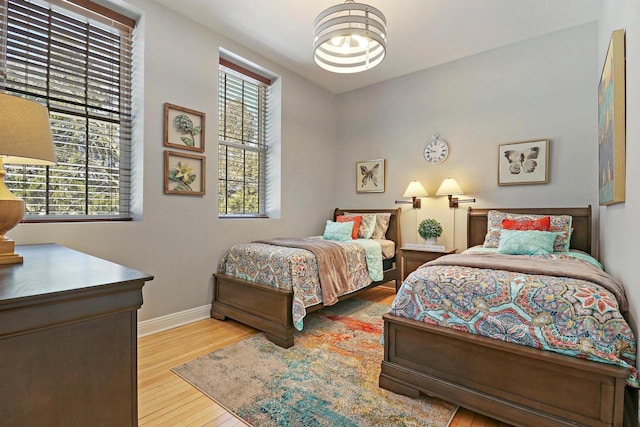 9302 39th Ave, Pleasant Prairie, WI 53158 - bedroom featuring multiple windows, wood finished floors, and baseboards