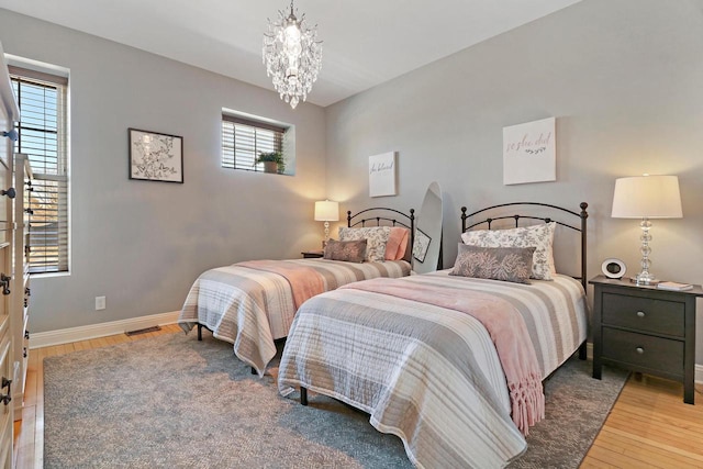 9302 39th Ave, Pleasant Prairie, WI 53158 - bedroom featuring light wood finished floors, a chandelier, and baseboards