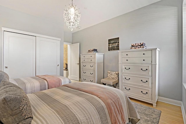 9302 39th Ave, Pleasant Prairie, WI 53158 - bedroom featuring light wood-style floors, baseboards, a closet, and a chandelier