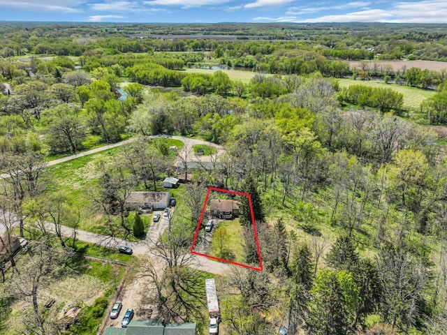 aerial view of property and surrounding area featuring property boundaries highlighted and a forest