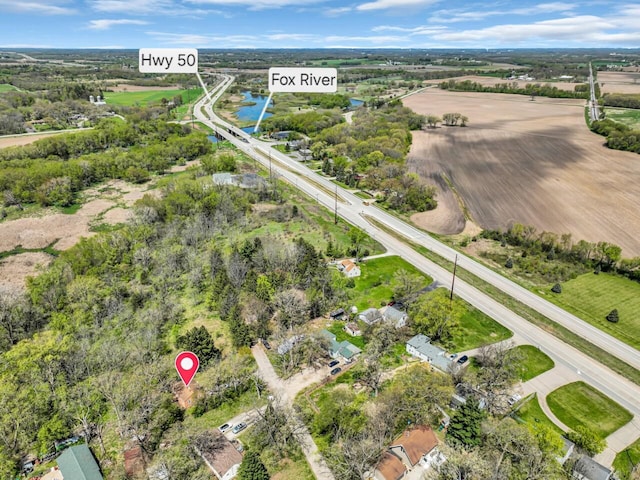 aerial view of property's location with a large body of water and a tree filled landscape
