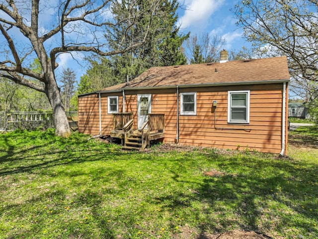 back of house featuring a chimney