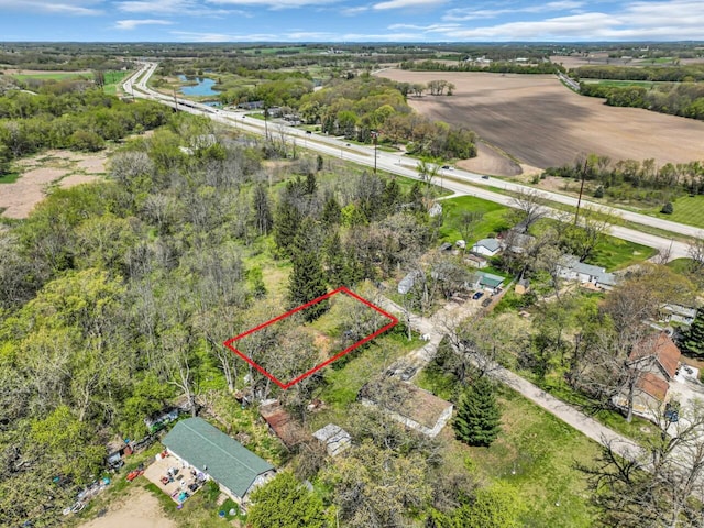 aerial view of property and surrounding area with property boundaries highlighted and a large body of water