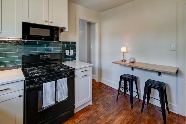 3112 Monroe St, Madison, WI 53711 - kitchen featuring black appliances, backsplash, dark wood finished floors, baseboards, and light countertops
