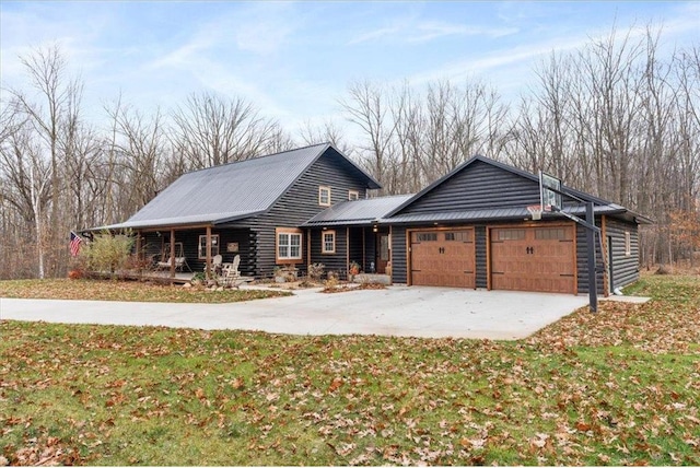 744 50th Ave, Clear Lake, WI 54005 - log home featuring a garage, driveway, metal roof, and a front lawn