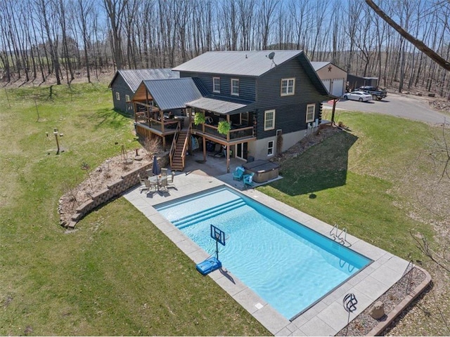 744 50th Ave, Clear Lake, WI 54005 - rear view of property with stairs, a deck, a yard, a hot tub, and metal roof