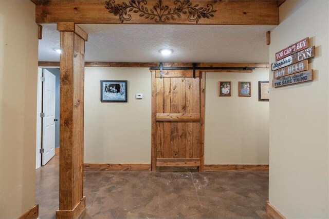744 50th Ave, Clear Lake, WI 54005 - finished below grade area with a barn door, baseboards, and a textured ceiling