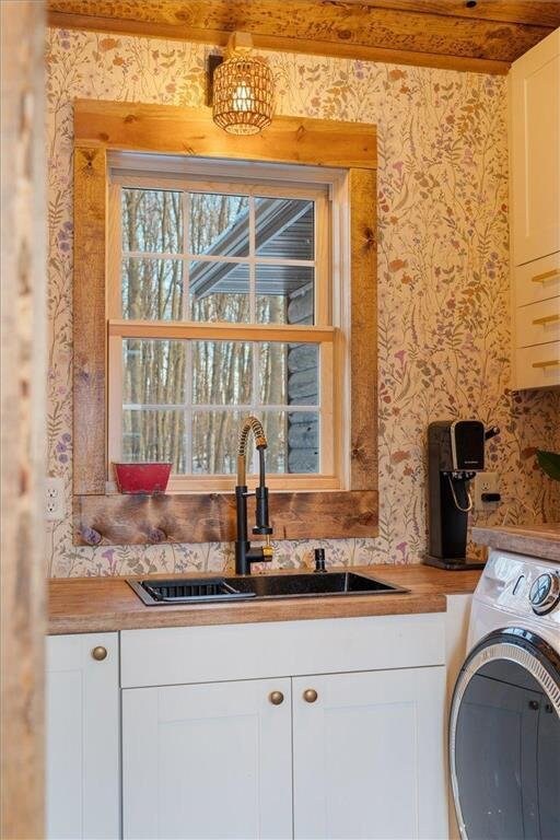 744 50th Ave, Clear Lake, WI 54005 - washroom featuring wallpapered walls, cabinet space, and washer / dryer