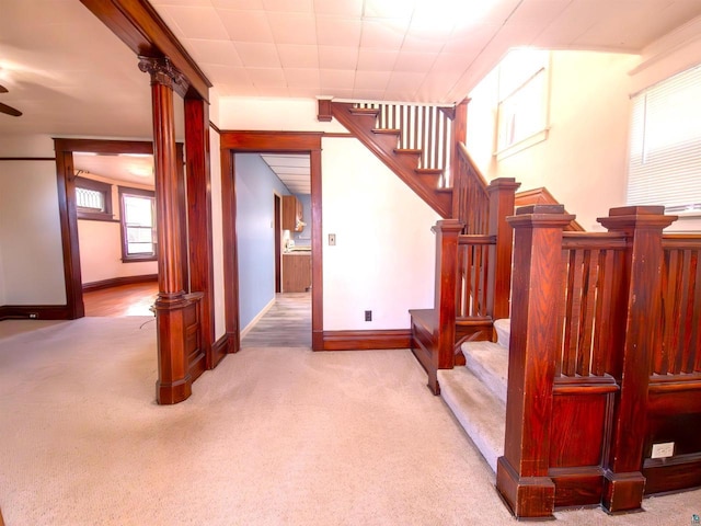stairs with carpet flooring, baseboards, and a ceiling fan