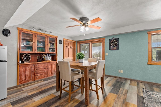 W3161 Julianna Ct, Chilton, WI 53014 - dining area featuring wood finished floors, ceiling fan, a textured ceiling, healthy amount of natural light, and baseboards