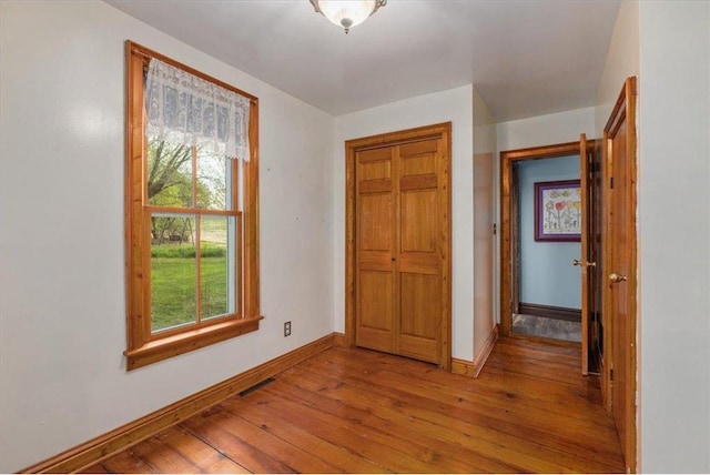 6300 Painter Rd, Mound, MN 55364 - hall with light wood finished floors, healthy amount of natural light, and baseboards