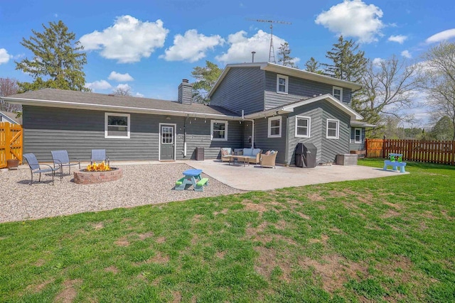 3877 Apple Ln, Oshkosh, WI 54902 - back of property with a patio area, an outdoor living space with a fire pit, and a chimney