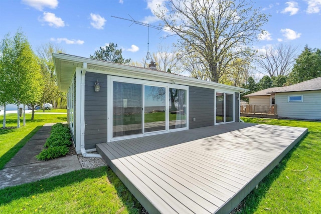 N8432 Minawa Beach Rd, Fond Du Lac, WI 54937 - back of property featuring a wooden deck, a yard, and a chimney