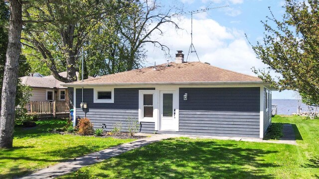 N8432 Minawa Beach Rd, Fond Du Lac, WI 54937 - rear view of house with a lawn, a chimney, and a shingled roof