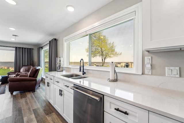 N8432 Minawa Beach Rd, Fond Du Lac, WI 54937 - kitchen featuring stainless steel dishwasher, a sink, white cabinets, open floor plan, and recessed lighting