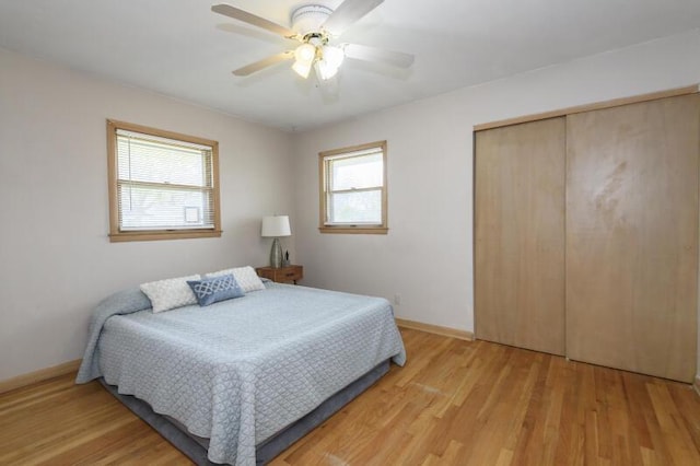 2334 W Custer Ave, Glendale, WI 53209 - bedroom featuring light wood-style flooring, a closet, baseboards, and ceiling fan