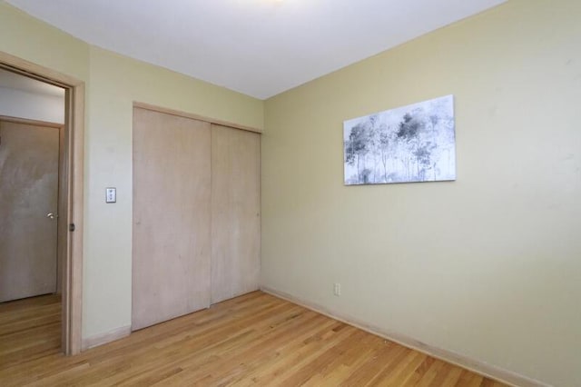 2334 W Custer Ave, Glendale, WI 53209 - unfurnished bedroom with a closet, light wood-style flooring, and baseboards