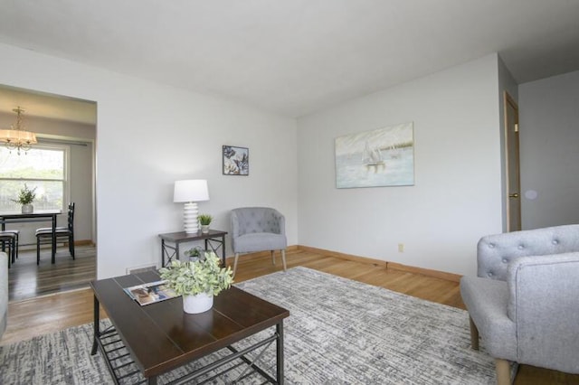 2334 W Custer Ave, Glendale, WI 53209 - living room with a chandelier, baseboards, and wood finished floors