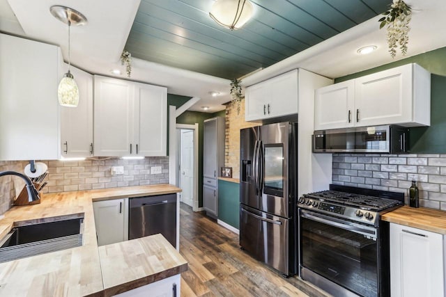 114 E Washington St, West Bend, WI 53095 - kitchen with butcher block countertops, stainless steel appliances, a sink, and tasteful backsplash