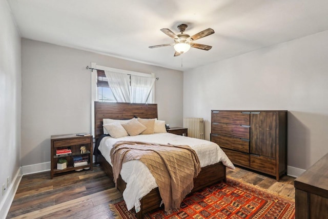 114 E Washington St, West Bend, WI 53095 - bedroom with radiator, wood finished floors, baseboards, and ceiling fan