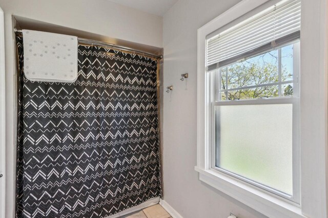 114 E Washington St, West Bend, WI 53095 - full bathroom with a shower with curtain and tile patterned floors