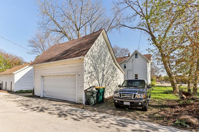 114 E Washington St, West Bend, WI 53095 - view of side of property with a garage and roof with shingles